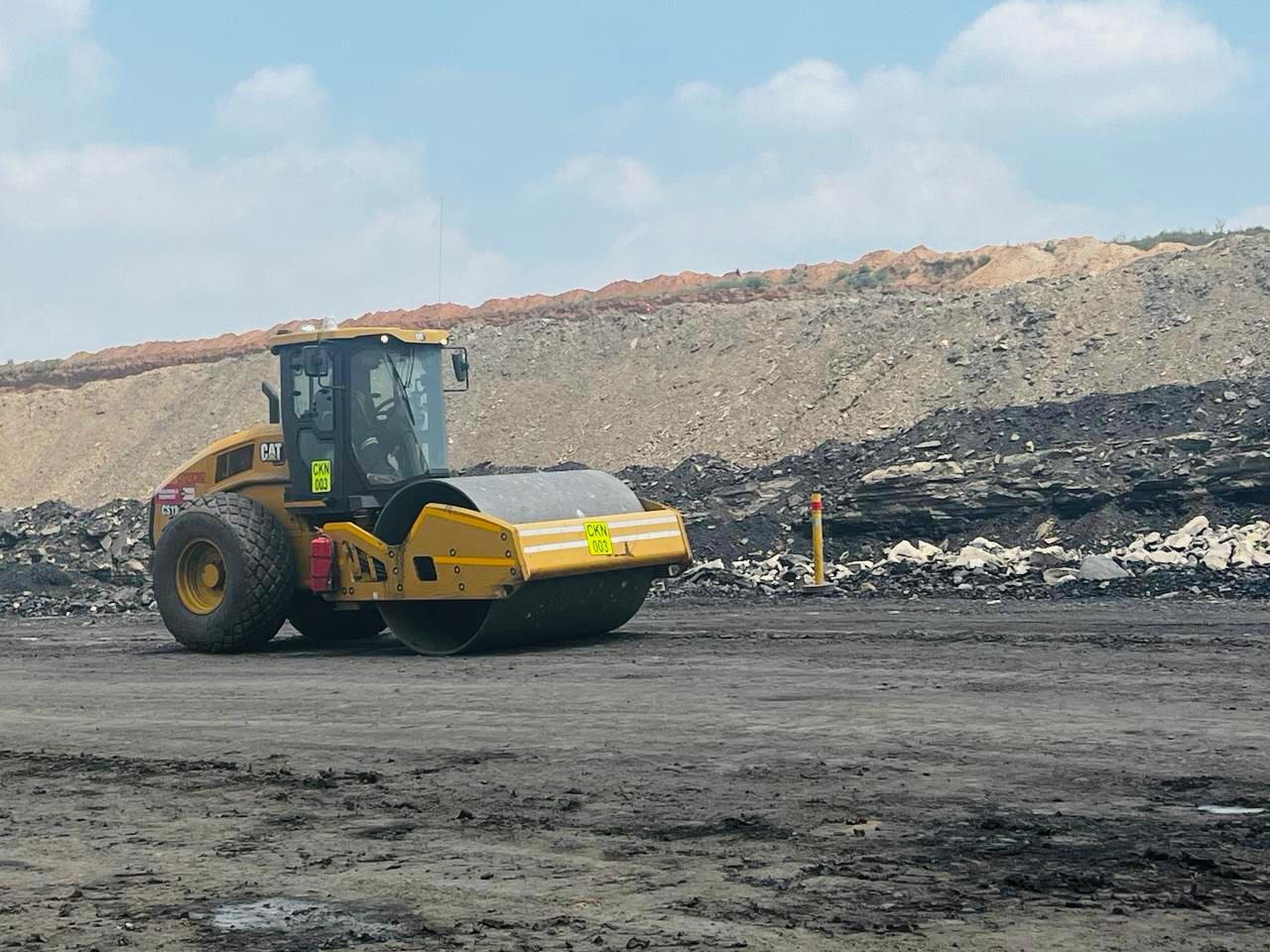 Roller compacting a pit floor